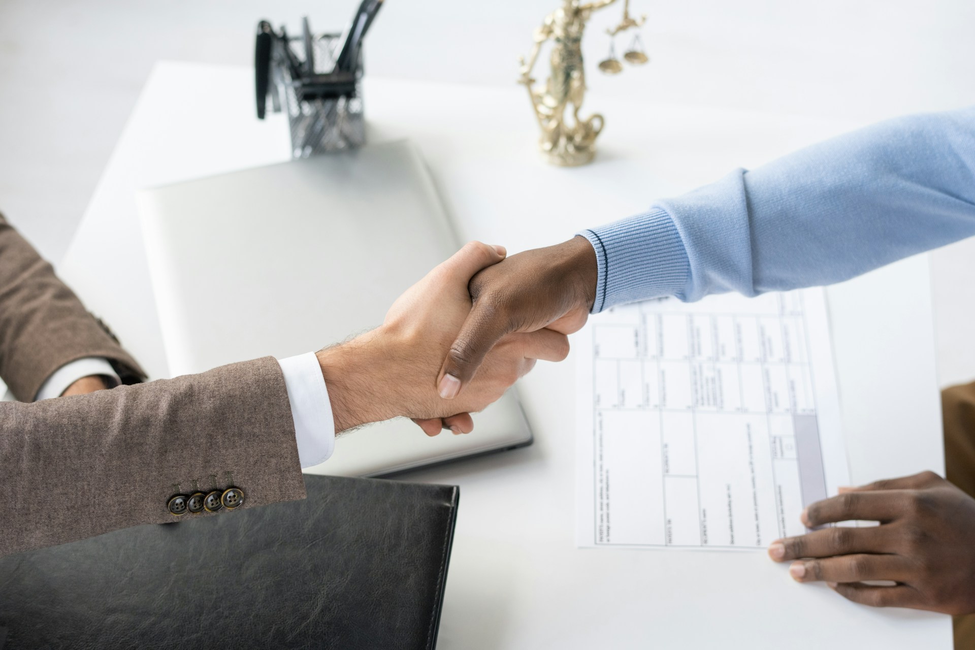 Client and consultant shaking hands after agreeing on help with a government contract